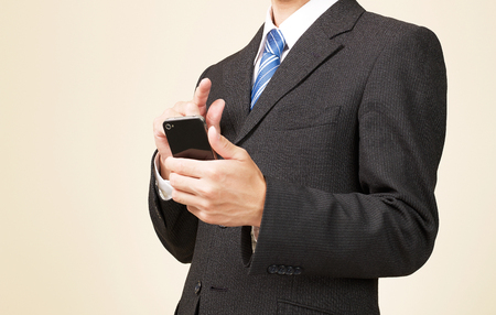 businessman holds smart phone, no faceの写真素材