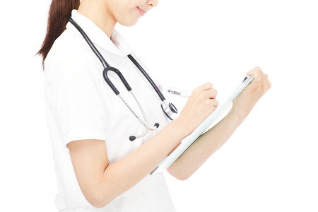 Japanese nurse writing the medical recordの写真素材