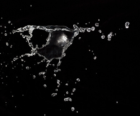 water splash isolated on black backgroundの写真素材