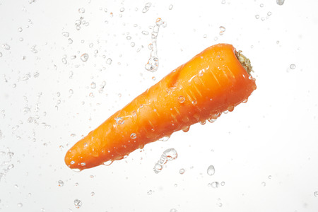 the carrot with water splashの写真素材