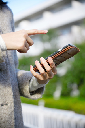 the woman using the smartphone, no faceの写真素材