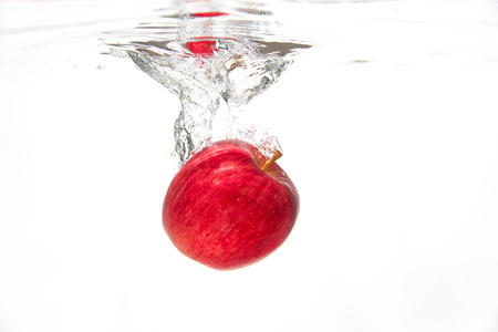 the apple under the waterの写真素材