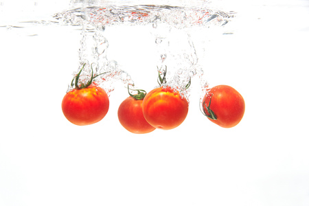 cherry tomato under the waterの写真素材
