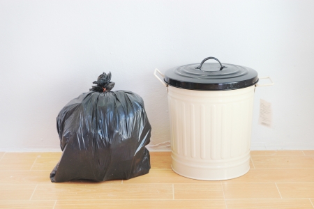 a black plastic bag and reuse disposal bin の写真素材