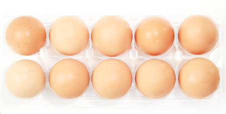 eggs in egg case box, white background.
