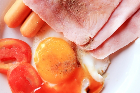 Close up break fast ham and fried egg on white dish.の写真素材