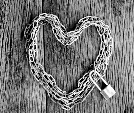 Chain heart shape with master key lock on wood backgroundの写真素材