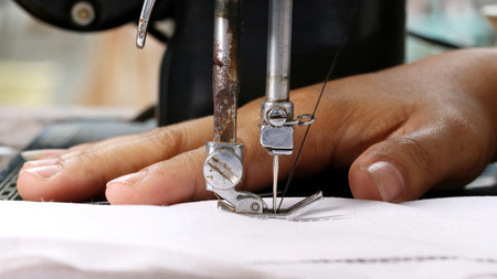Woman hand, working with sewing machine, close up 