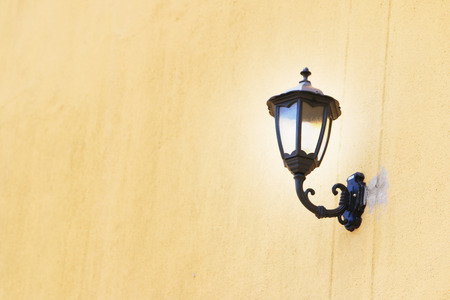 Old style Street lamp on wall.の写真素材