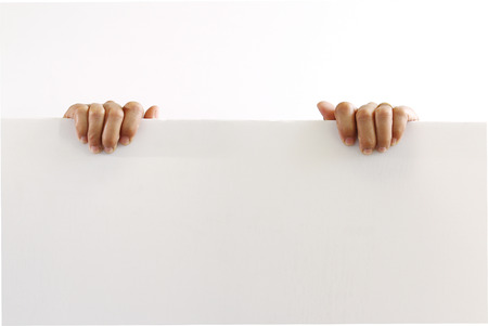 Paper blank empty board  in woman hand isolated on white backgroundの写真素材