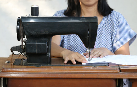 Close up woman working with sewing machine.