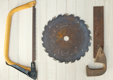 Old saws on wood background.