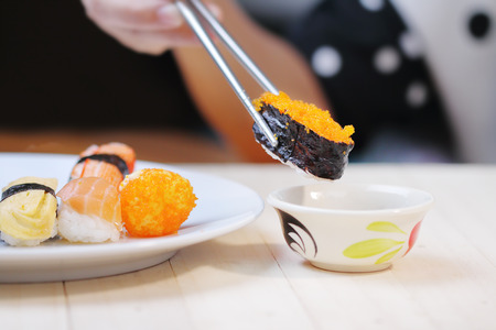 Sushi keep chopsticks and dipped into the sauce,Japanese Food.の写真素材