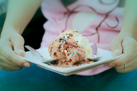 Woman hand hold a dish ice cream.vintage.の写真素材