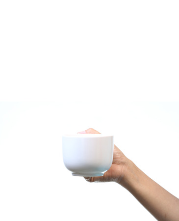 Woman hand holding white coffee cup, isolate on white.の写真素材