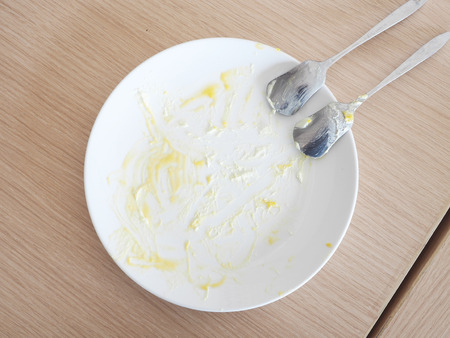 Empty white dish after cake on the table.の写真素材