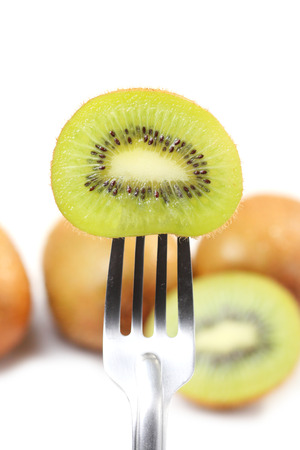 Kiwi and fork on white backgroundの写真素材