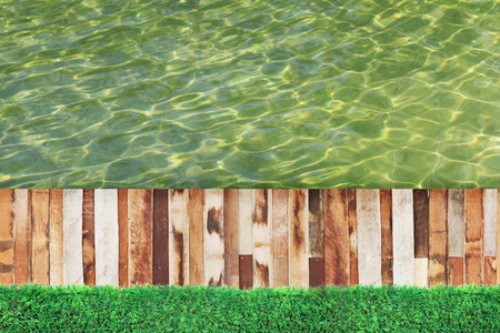 Green grass, plank wood and water background.の写真素材