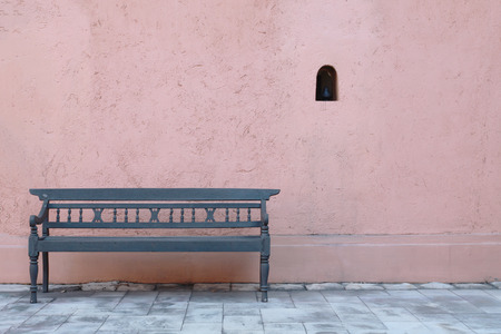 Vintage wood sofa, pink wall background.の写真素材