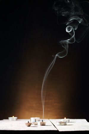 Incense cone or gum benjamin with abstract smoke, black background.の写真素材