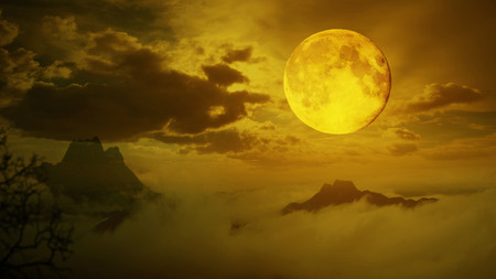 Dramatic sky with tree, full moon and clouds over mountain, Warm orange tone.の写真素材