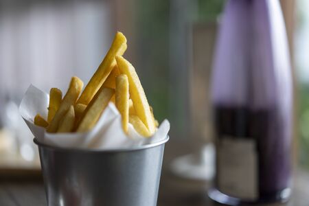 French fries with tomato sauce placed on the tableの写真素材