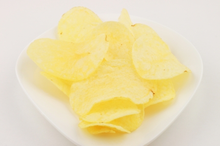 fried potato chips in white plate on white background の写真素材