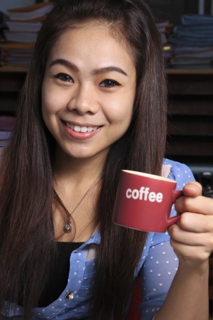 office girls enjoying a cup of coffee の写真素材
