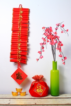 chinese new year ornaments and vase of flowers の写真素材
