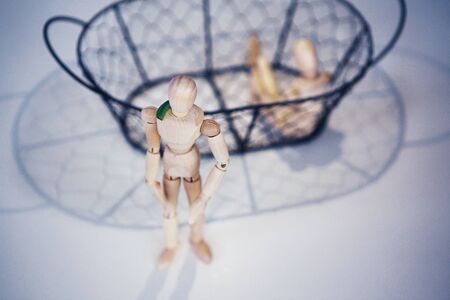 Wooden men sits on opposite sides.の写真素材