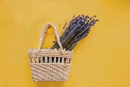 Handmade natural organic bag and lavender flowers on yellow background flat lay. Copy space, top view. Ecobags. Eco-bag concept.の写真素材