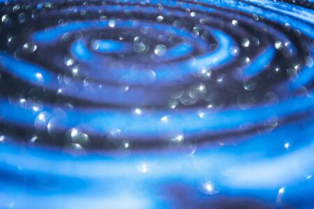 Blackground of abstract glitter lights. blue, silver and white. de focused.