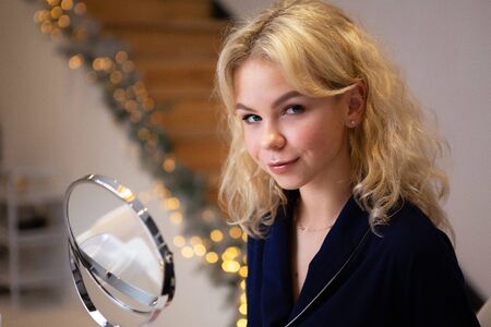 Blonde girl getting ready to do makeup, face care, facial skin care. Beauty concept.の写真素材