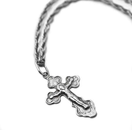 Cross on a chain on a white background closeの写真素材