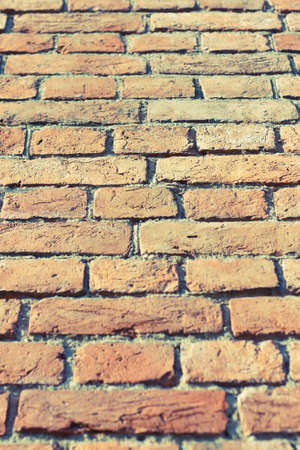 Dilapidated brick wall with remnants of plasterの写真素材