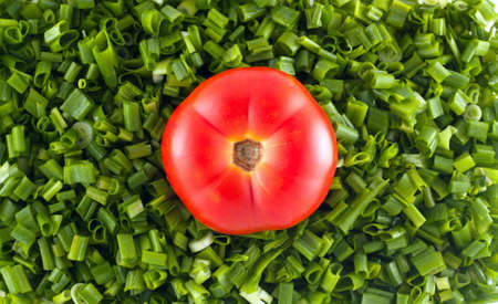 Shredded onion with ripe tomatoes on topの写真素材