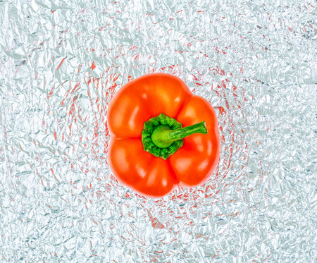 Bell peppers of red colors on crumpled foil. Pepper closeup.の写真素材