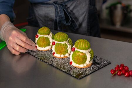 Confectioner makes a cake in the form of figures of Christmas heroes. Handworkの写真素材