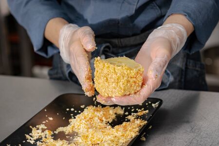Confectioner makes a cake with cream and raspberries.の写真素材