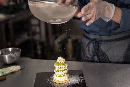 Confectioner makes a cake in the form of figures of Christmas heroes. Handwork