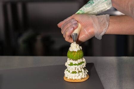 Confectioner makes a cake in the form of figures of Christmas heroes. Handworkの写真素材