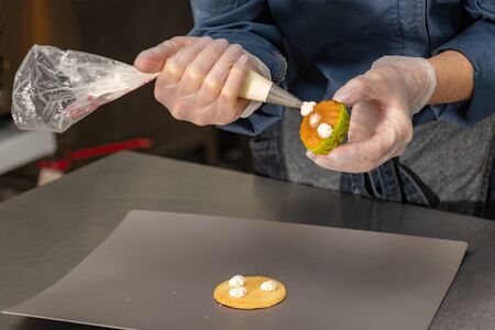 Confectioner makes a cake in the form of figures of Christmas heroes. Handworkの写真素材