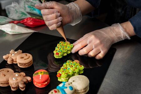 Confectioner makes a cake in the form of figures of Christmas heroes. Handworkの写真素材