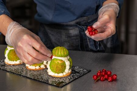 Confectioner makes a cake in the form of figures of Christmas heroes. Handworkの写真素材