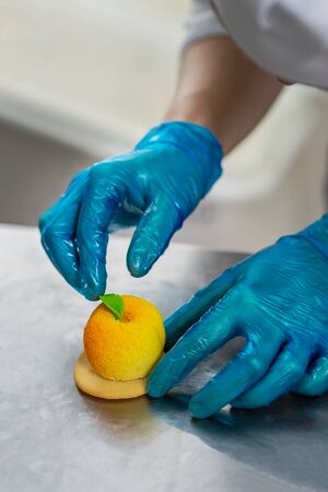 Confectioner makes a cake in the shape of fruits and berriesの写真素材