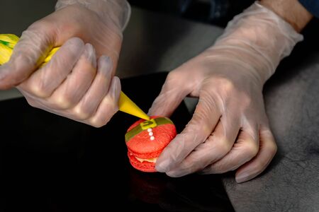 Confectioner makes a cake in the form of figures of Christmas heroesの写真素材