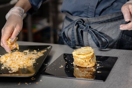 Confectioner makes a cake with cream and raspberries.の写真素材