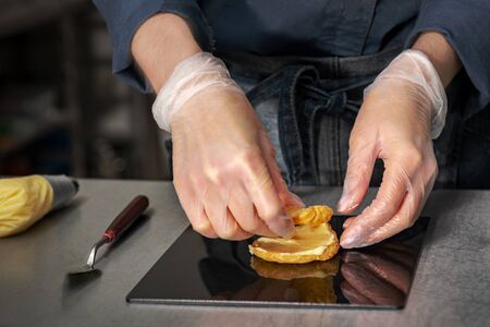 Confectioner makes a cake in the form of figures of Christmas heroesの写真素材