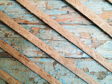 Damaged old grunge wood blue wall with peeling paint textureの写真素材