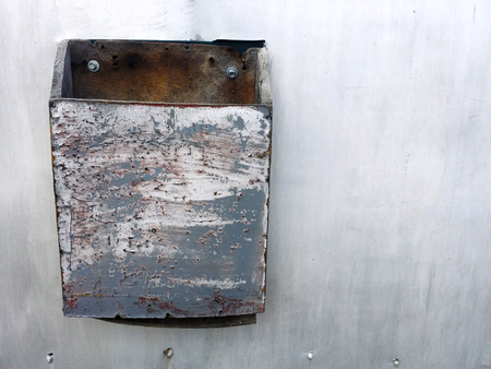 grunge background of grey metal fence with dirty letterboxの写真素材